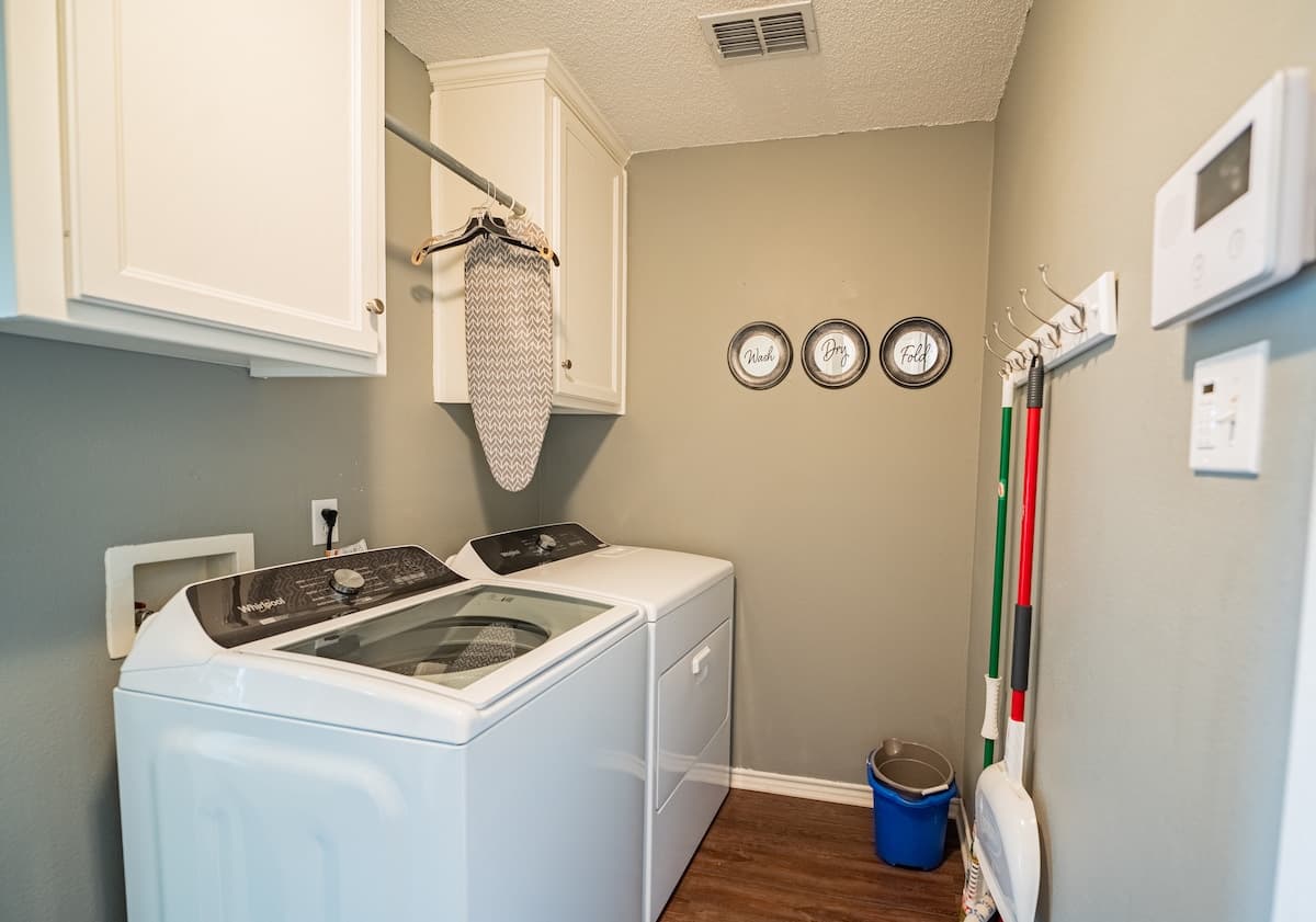 Laundry room equipped with a washer and dryer.